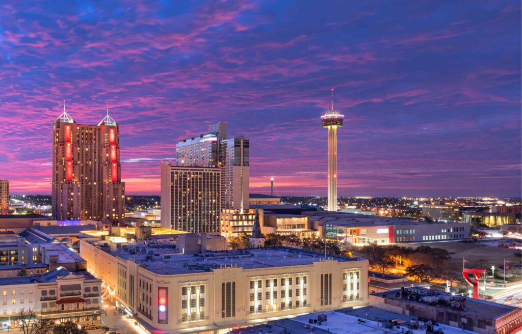 San Antonio skyline with the Tower of the Americas glowing at sunset.