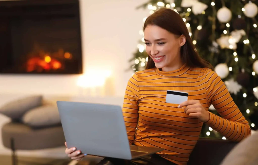 woman comparing credit card options on a laptop while learning how to choose a new credit card for a new year financial reset