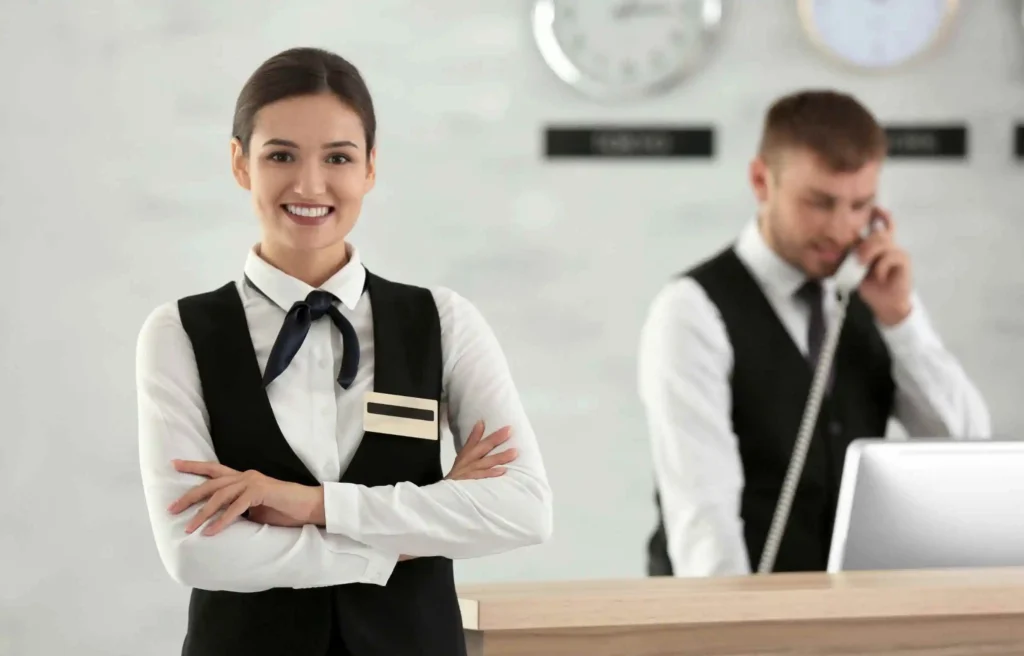 Hotel reception staff assisting guests with check in as part of the best way to earn southwest companion Pass.