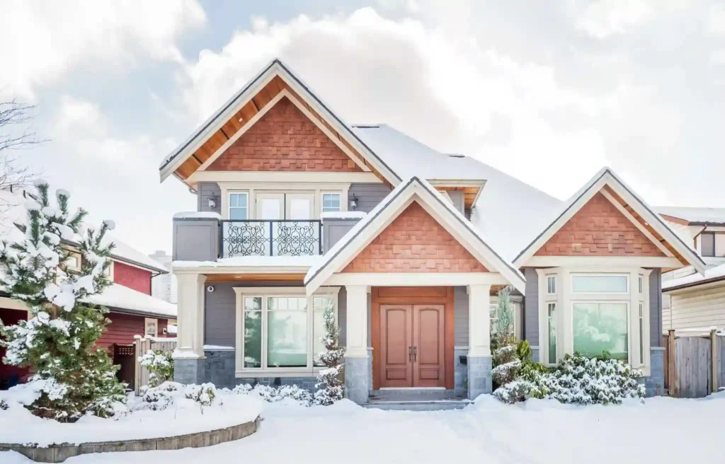 Snow-covered home seen while relocating in january during a calm winter housing market.