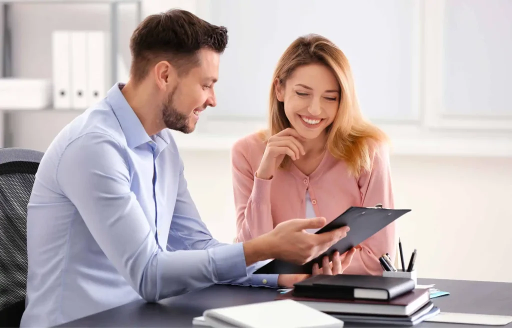 Two professionals reviewing financial documents comparing traditional banks vs neobanks during a banking consultation.