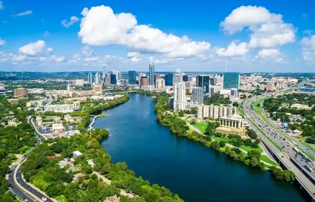 Austin skyline by the river, reflecting a city drawing ai workers and innovation.