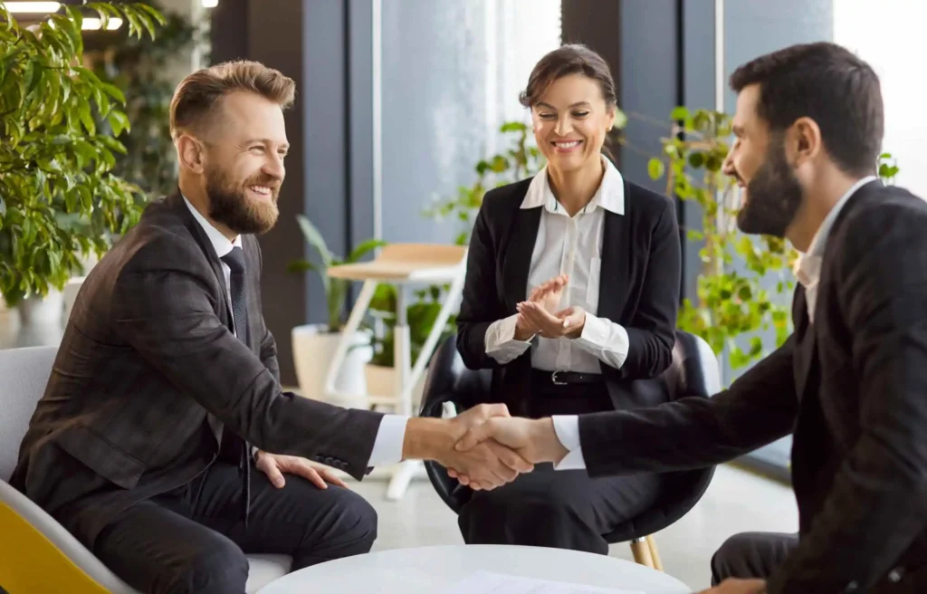 Business leaders sealing a partnership through eor employee relocation solutions agreement.