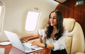 Happy Woman Working in First Class Flight - Relo