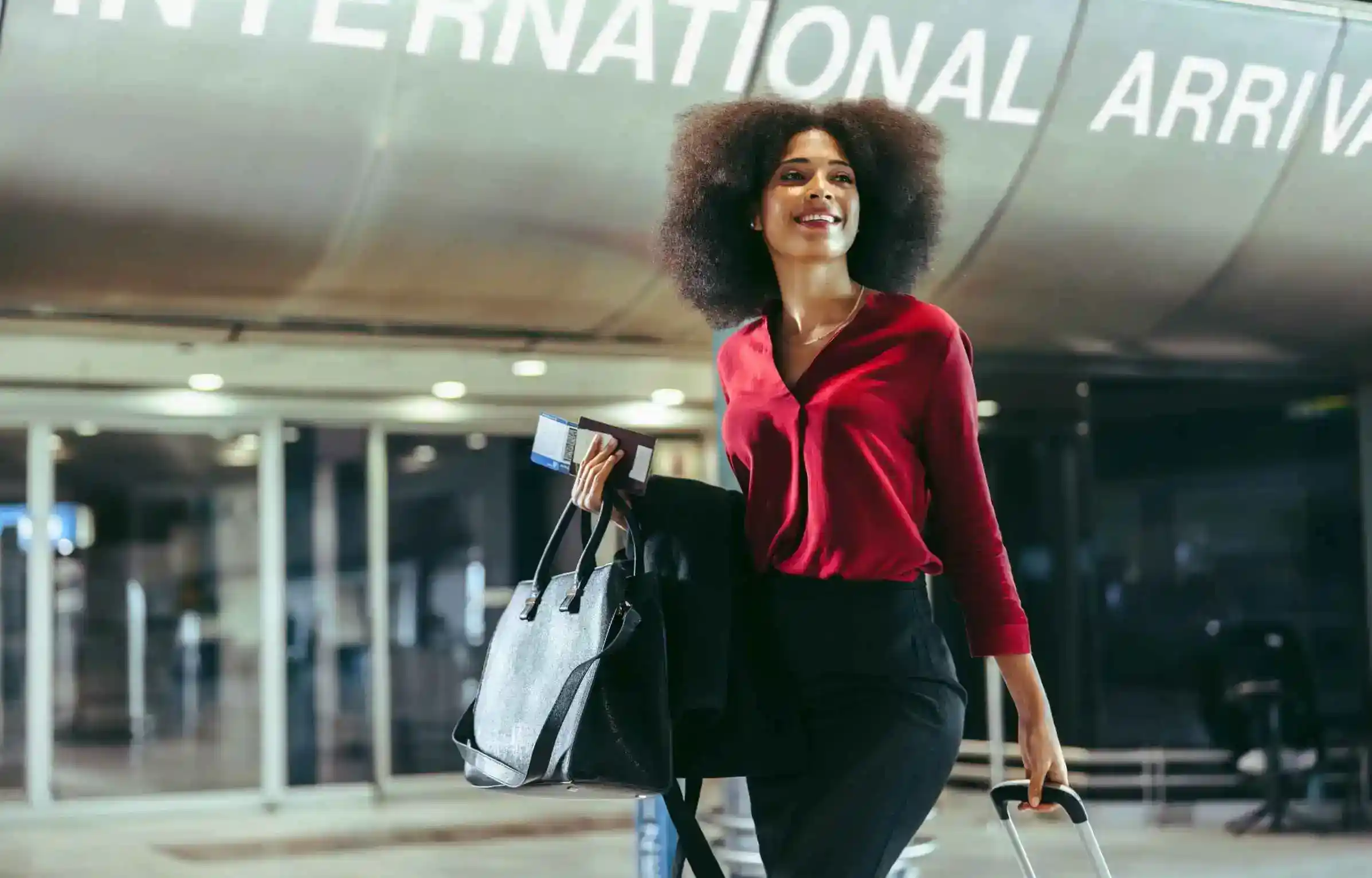Businesswoman arriving at an international airport for a corporate business trip.