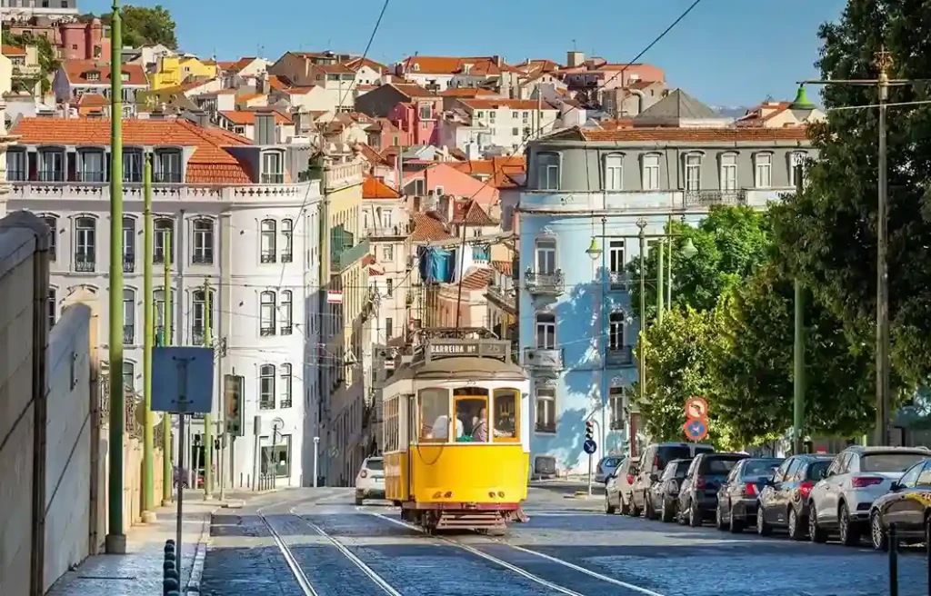Lisbon street with historic buildings and tram, showing a popular base for remote AI workers.