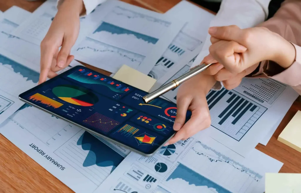 Tablet displaying migration charts and corporate relocation statistics on financial reports.