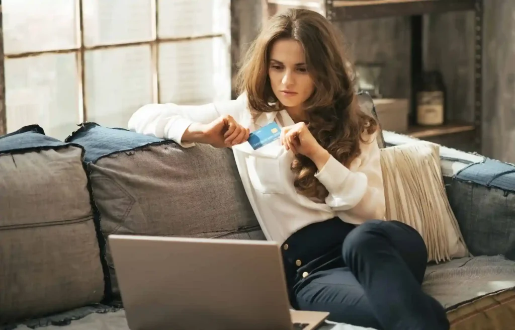 Woman researching how to get approved for a home depot credit card on laptop at home.