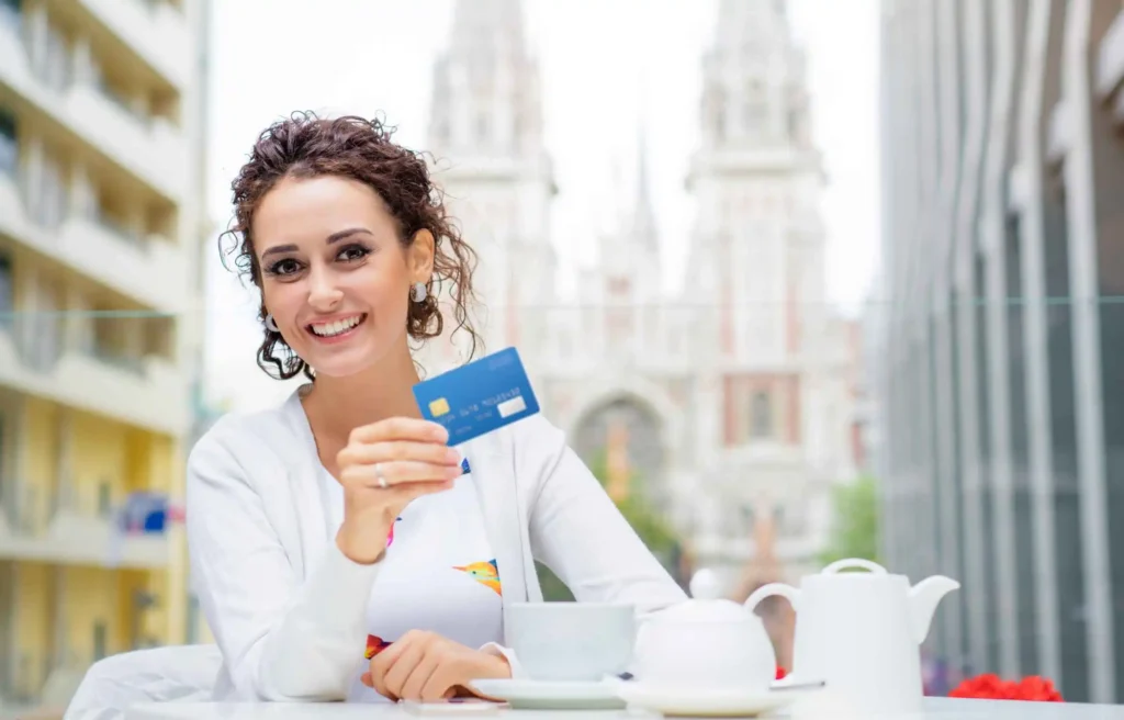 Woman holding credit card highlighting bofa rewards program cashback boost benefits.