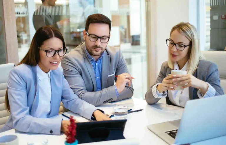 HR team analyzing corporate relocation policy details during strategic planning meeting.