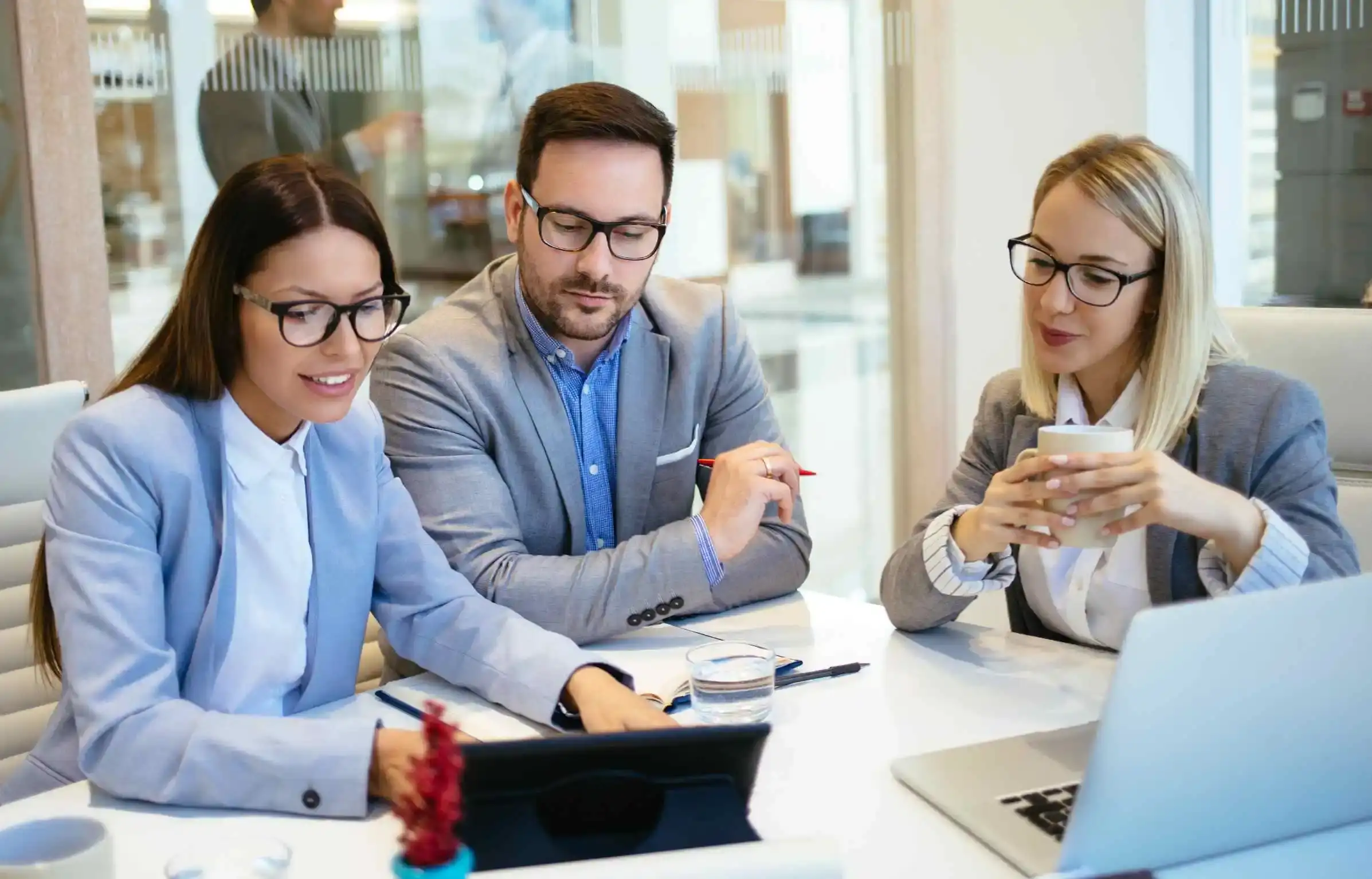 HR team analyzing corporate relocation policy details during strategic planning meeting.