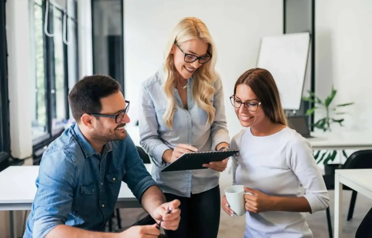 HR team reviewing relocation plan and discussing corporate relocation costs in a modern office.