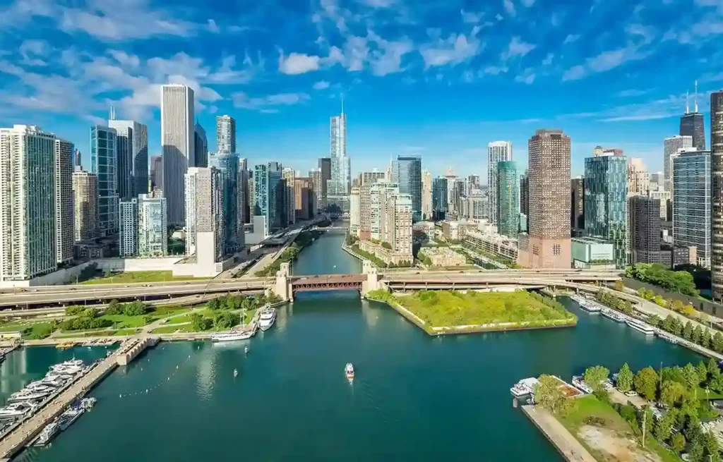Illinois Chicago skyline with riverfront bridges, skyscrapers, and boats along the Chicago River.