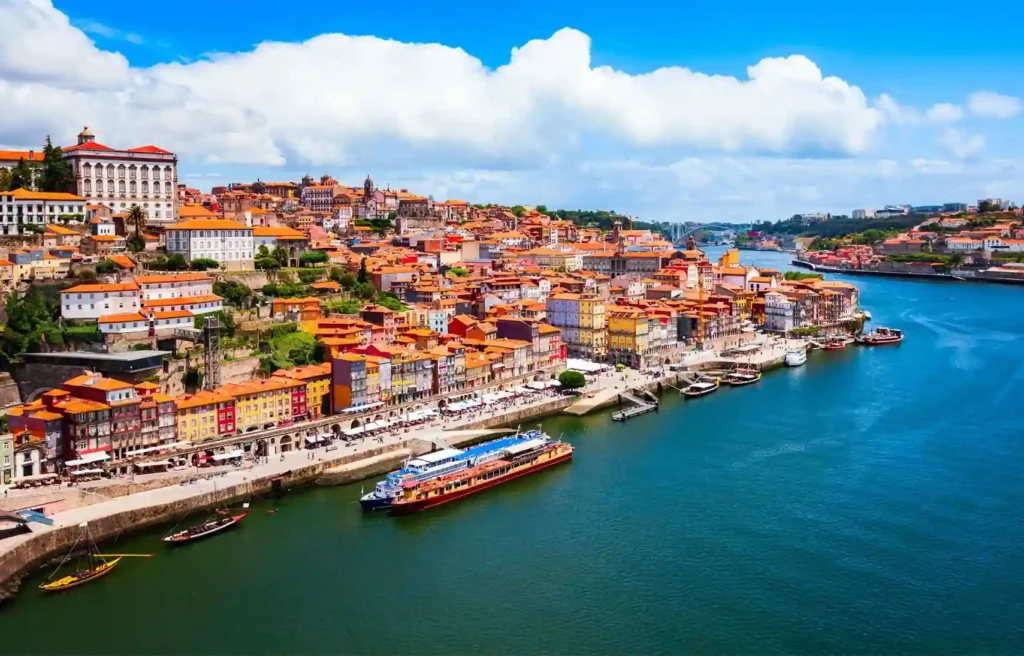 Scenic riverfront city with colorful buildings in Portugal, ranked among the safest countries 2026 for relocation.