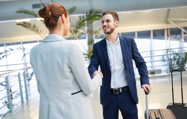 Professional relocation service helping client during move with travel luggage.