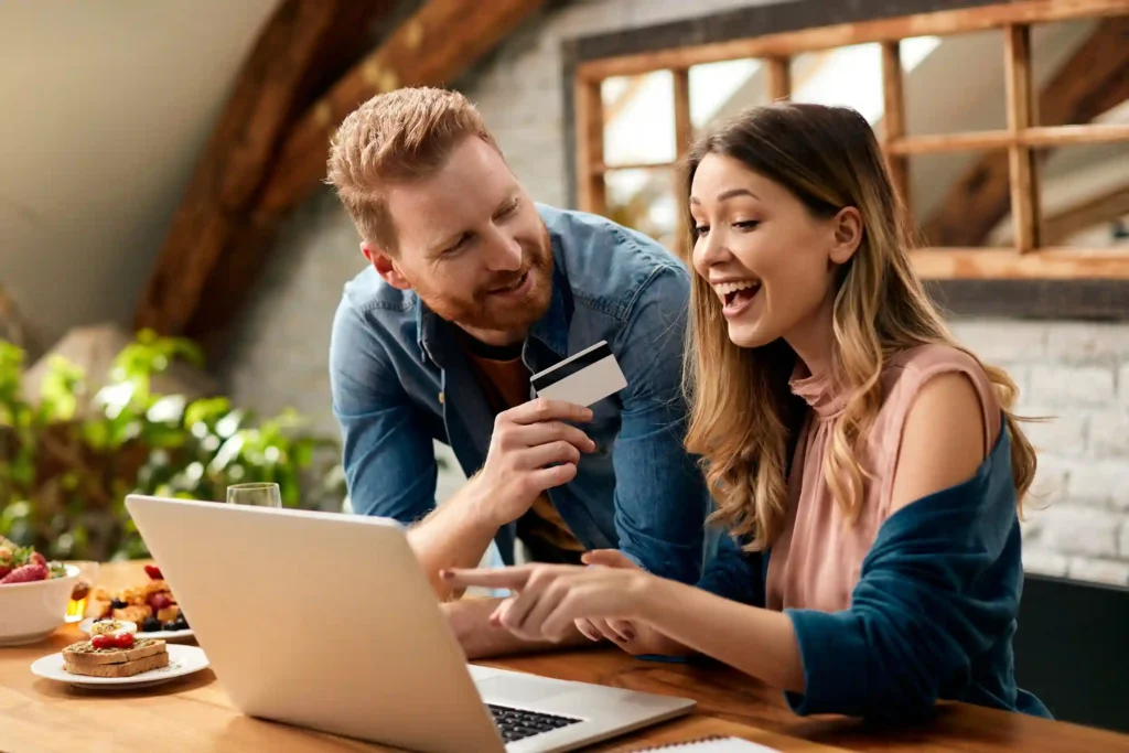 Couple holding a credit card representing smart relocation spending and reward earning during a move to a new city