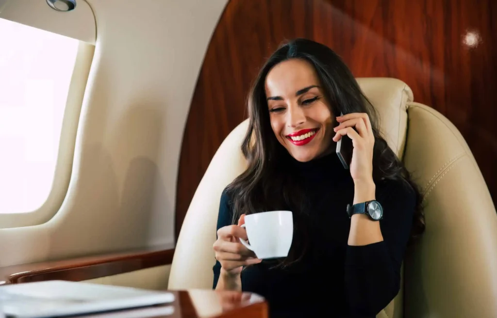 Business class traveler enjoying luxury flight using points to Use sign-up bonuses to fund your relocation.