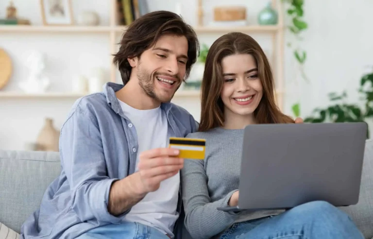Couple using credit card online to plan relocation using rewards and sign-up bonuses.