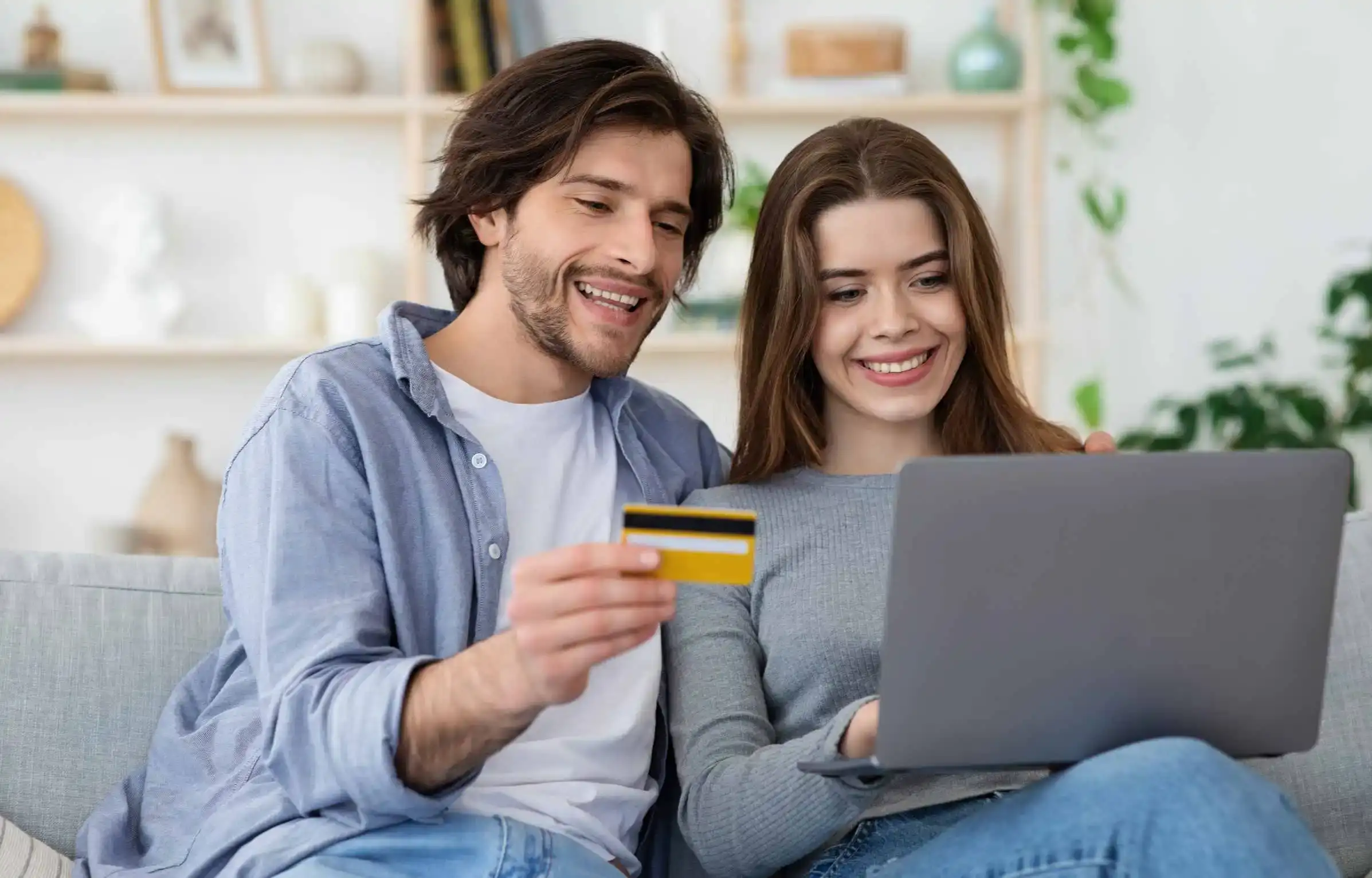 Couple using credit card online to plan relocation using rewards and sign-up bonuses.
