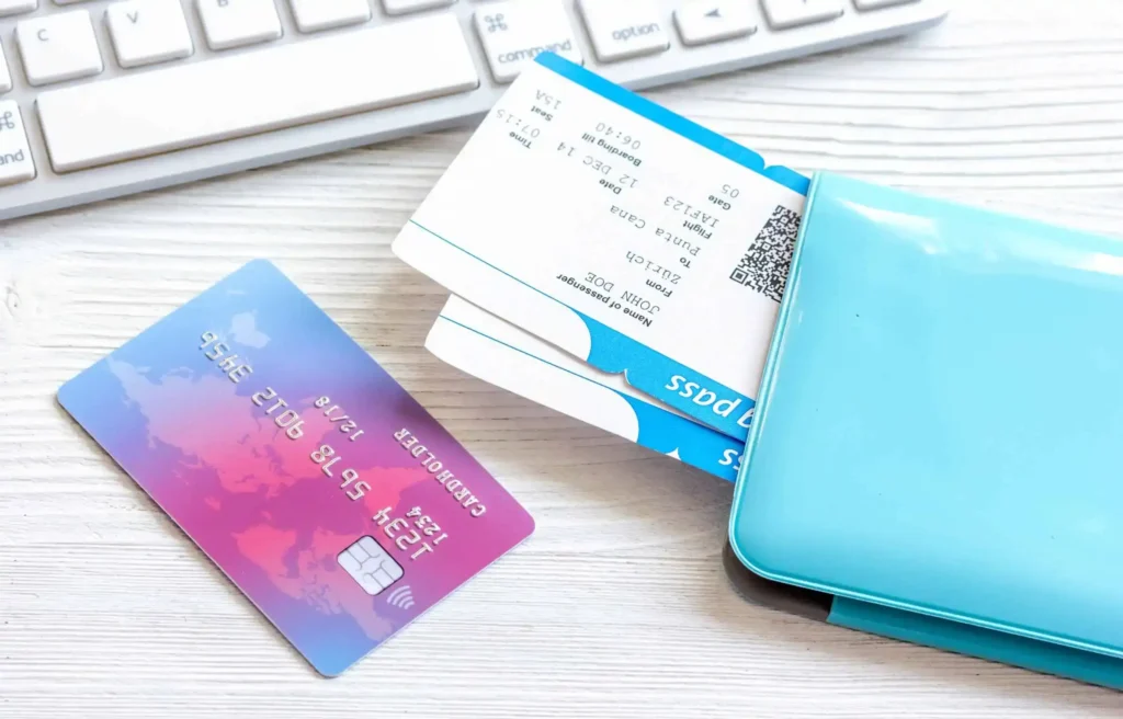 Credit card and boarding passes in holder showing travel planning with best cards for earning miles.