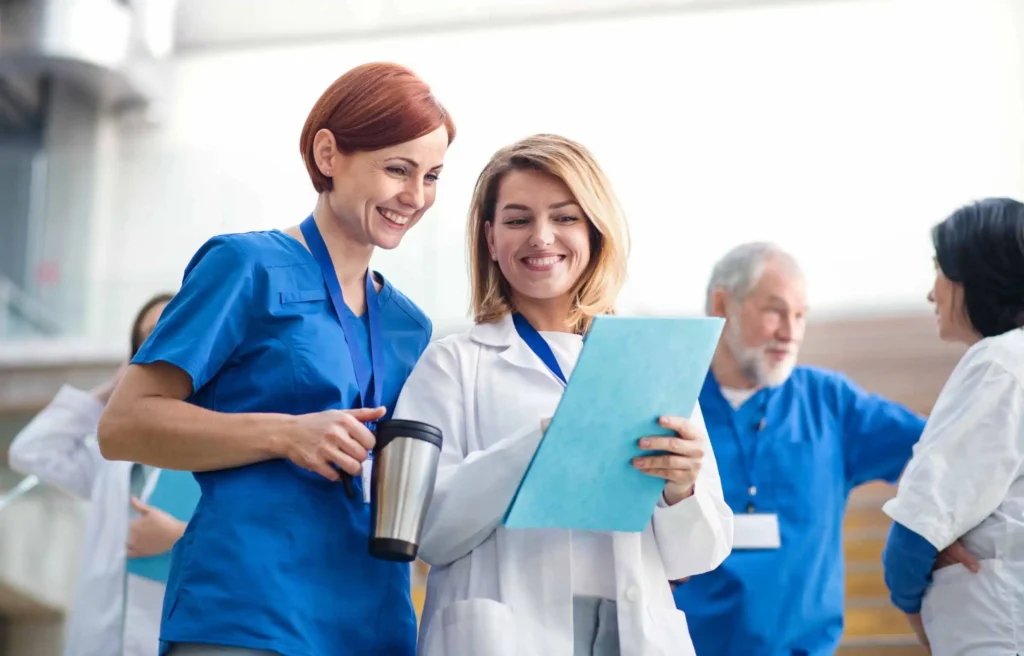 Medical staff in discussion highlighting challenges of the US physician shortage.