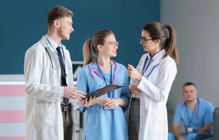 Doctors and nurses collaborating as staffing shortages strain healthcare systems.