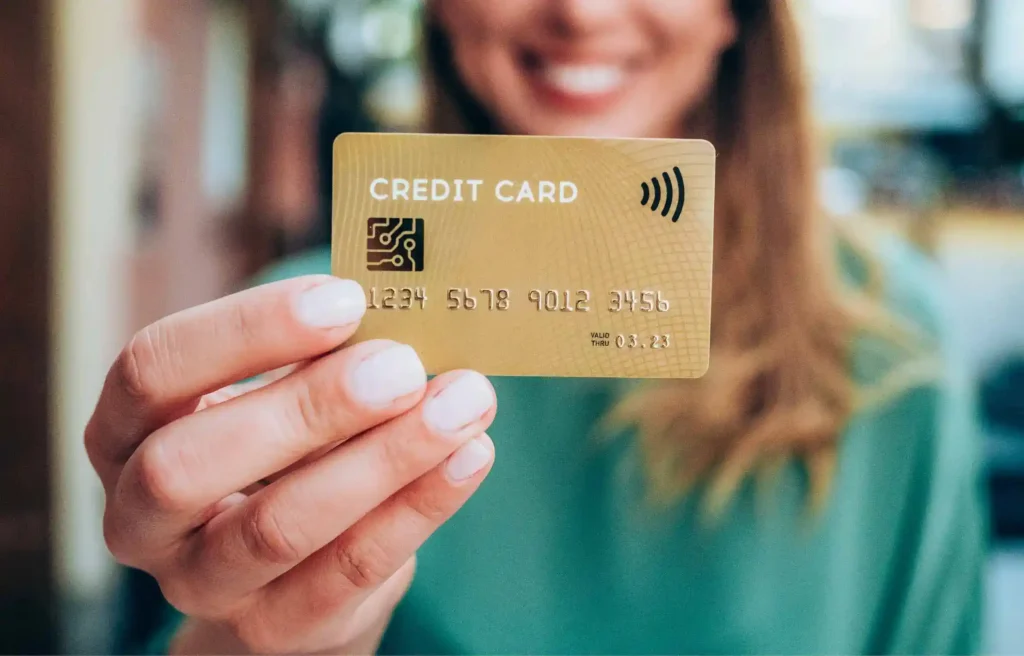 Woman holding a credit card close-up for payment during toronto relocation.