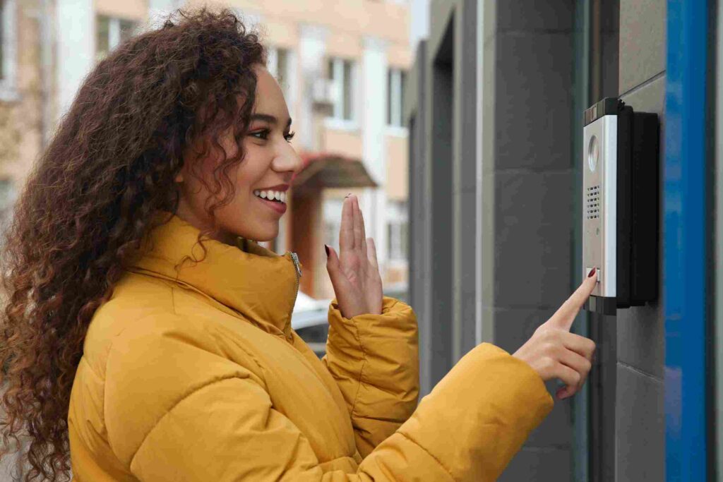 woman using video doorbell as Apartment Security Setup