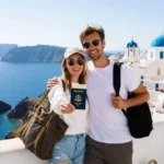 An American couple holding passports in Santorini, Greece.