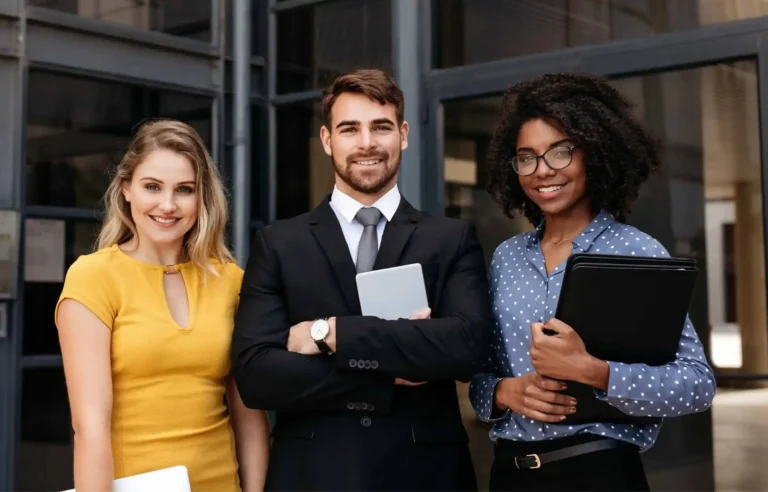 Business team standing outside office during employee relocation planning.