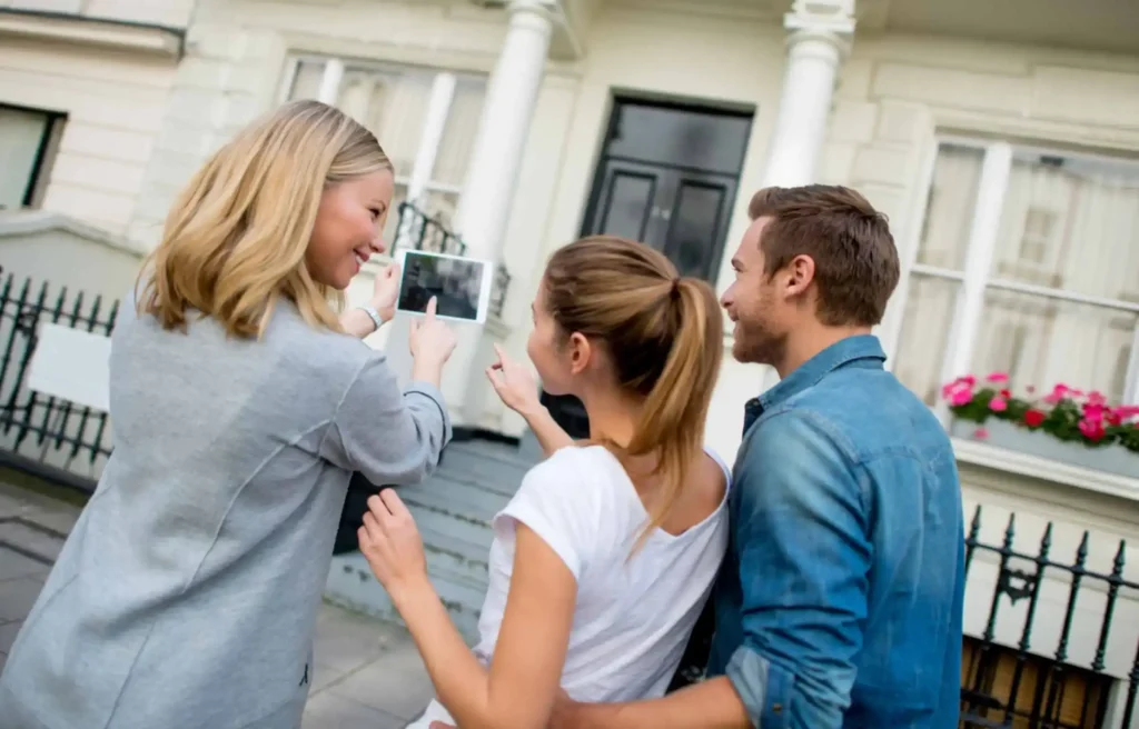 Home buyers touring a property with an agent before making a purchase decision.