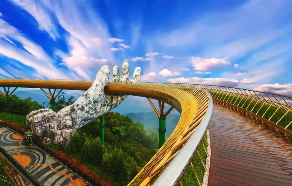 Golden Bridge held by giant stone hands above the mountains near Da Nang.