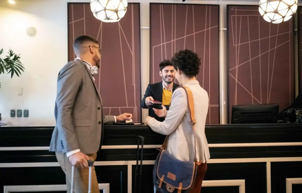 Hotel guests checking in at the front desk, hilton honors gold vs diamond.