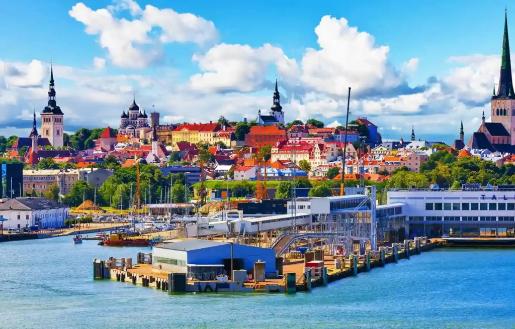 Tallinn Old Town skyline and harbour under a bright blue sky.