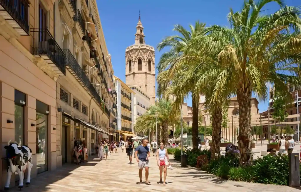 Palm-lined pedestrian street near Valencia Cathedral in central Valencia.