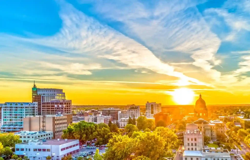 Boise, Idaho downtown skyline and capitol dome glowing at sunset.
