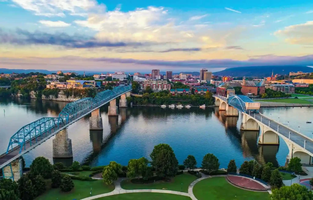 Chattanooga, Tennessee river bridges and downtown skyline at dusk.
