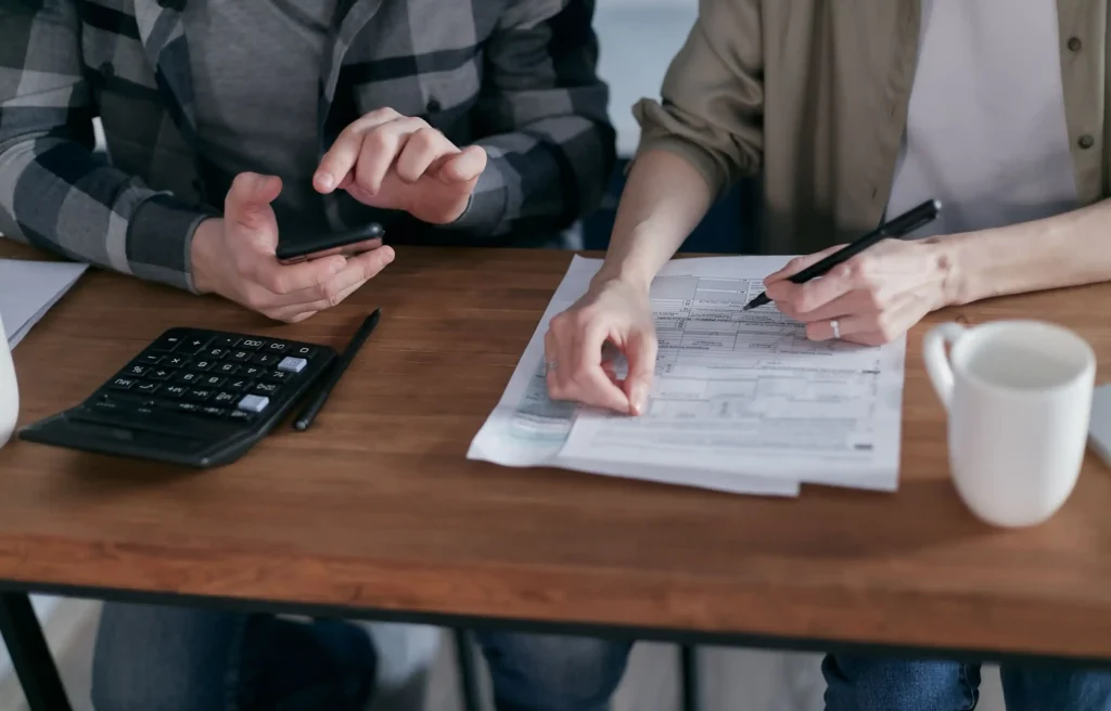 Couple reviewing finances and relocation costs before moving from Los Angeles to Dallas.