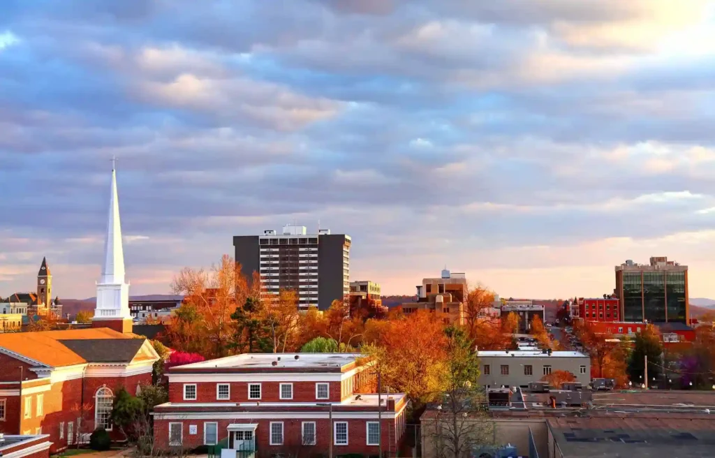 Fayetteville, Arkansas downtown skyline and church steeple beneath a dramatic sky.