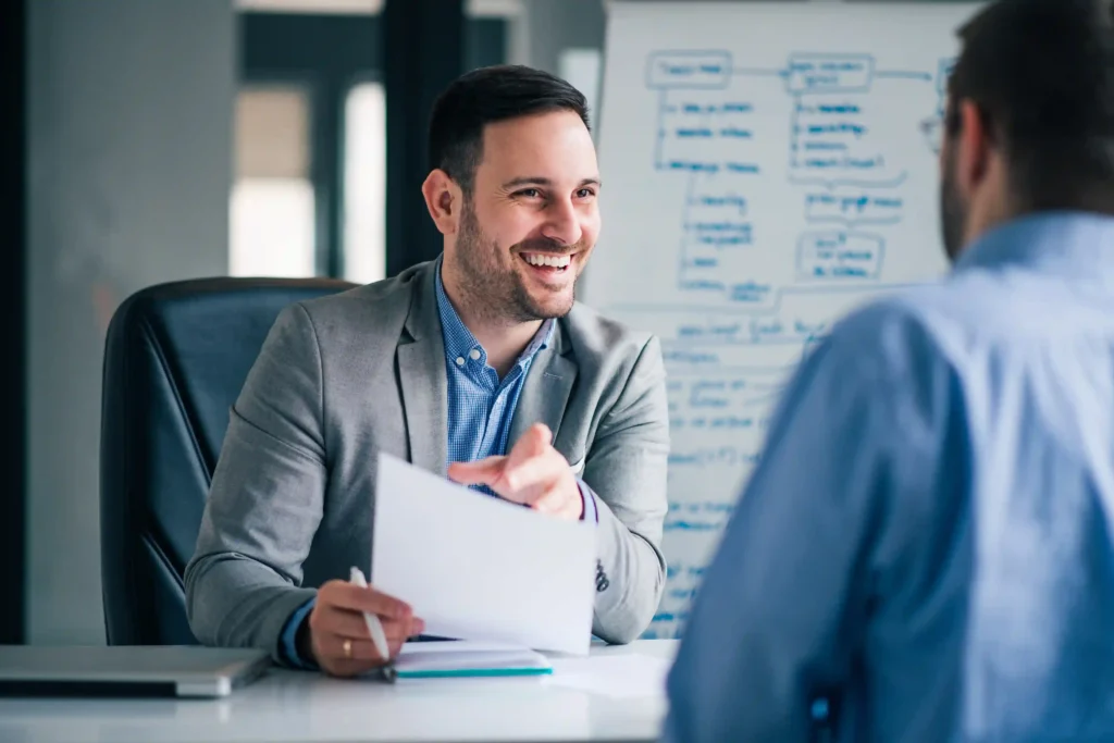 HR leader reviewing a relocation package with an employee to address relocation challenges in a corporate office.