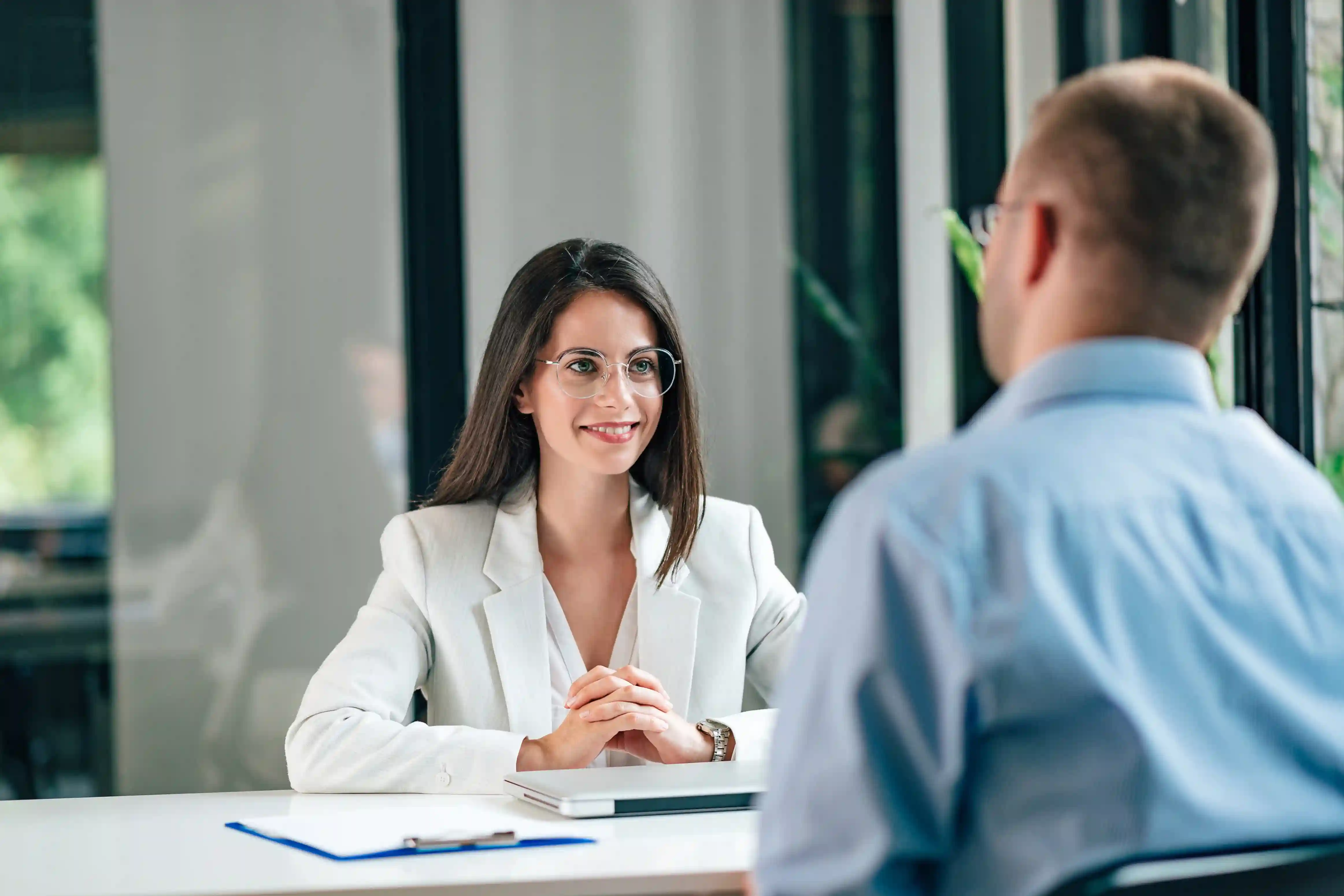 HR manager discussing employee relocation challenges during an office meeting.