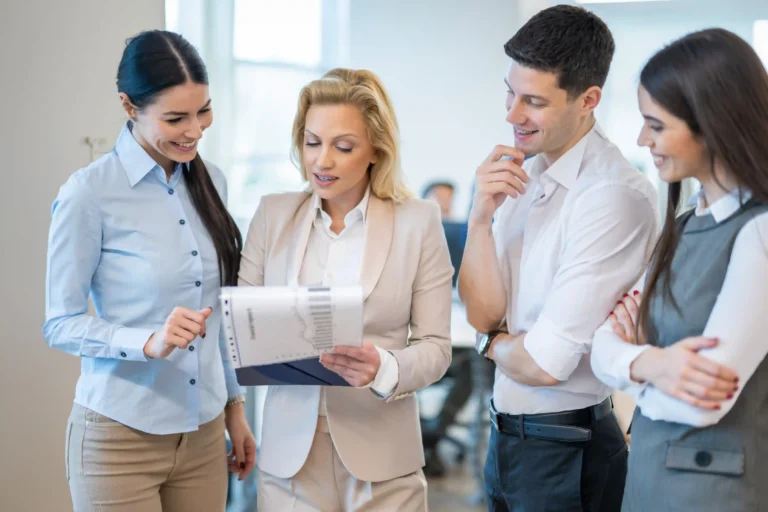 HR team reviewing a core-flex relocation policy document in a bright office.