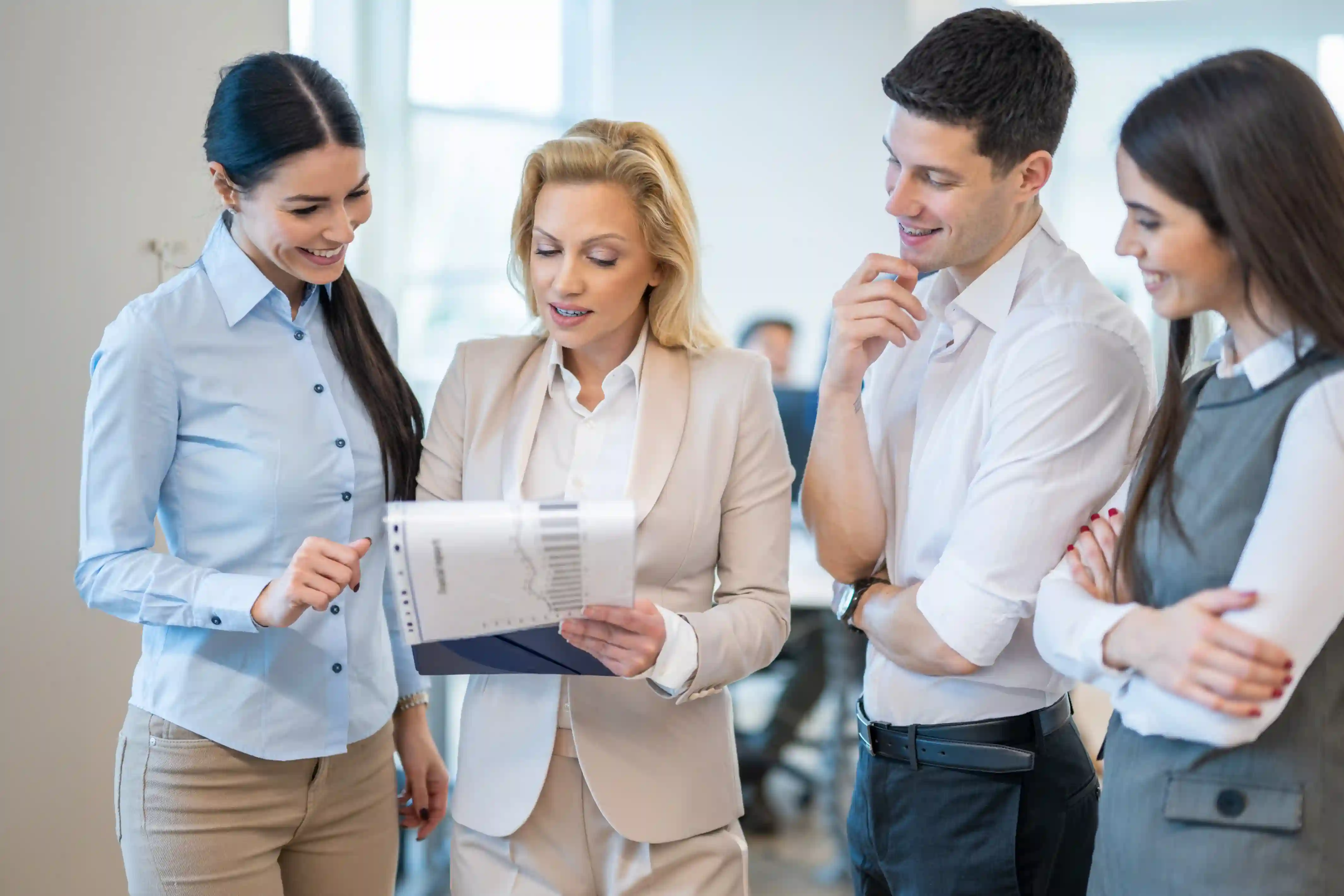 HR team reviewing a core-flex relocation policy document in a bright office.