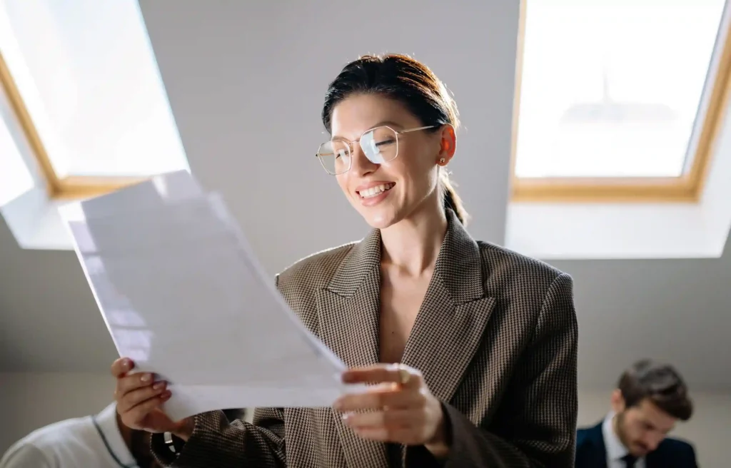 Professional reviewing a relocation repayment agreement in a bright office.