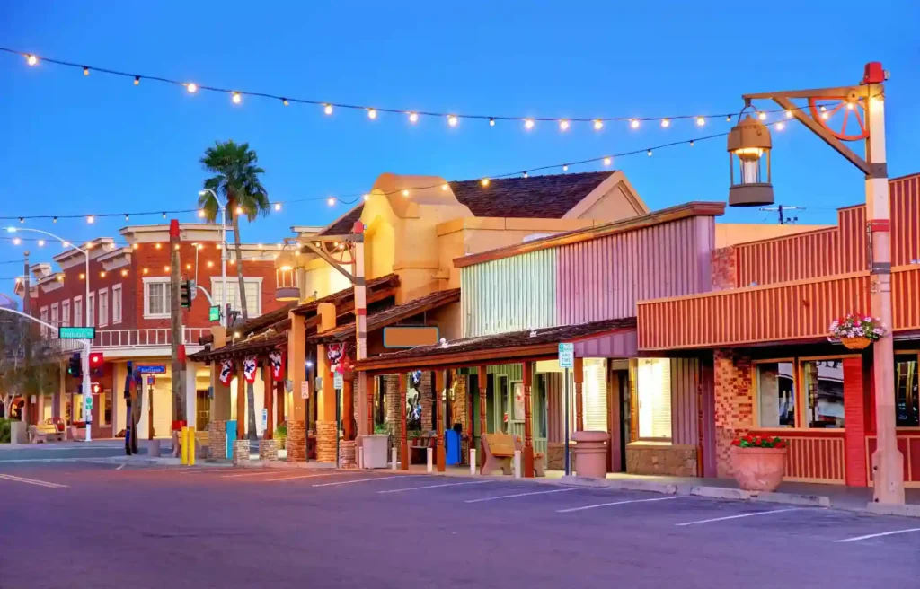 Scottsdale, Arizona Old Town streetscape with palms and lit storefronts at dusk.