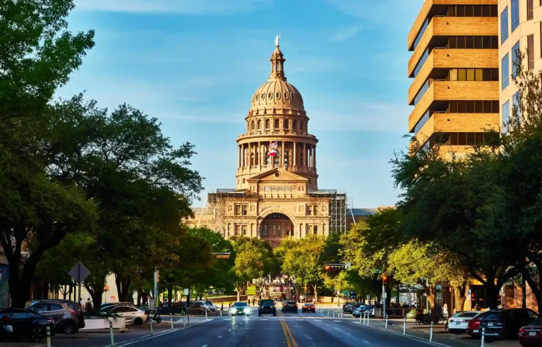 Texas State Capitol viewed from Congress Avenue in downtown Austin on a sunny day.