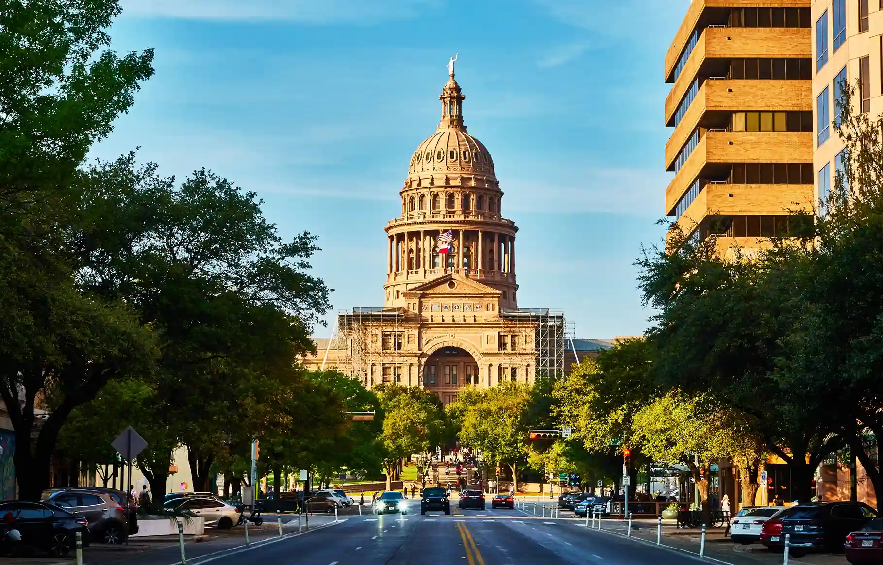 Texas State Capitol viewed from Congress Avenue in downtown Austin on a sunny day.