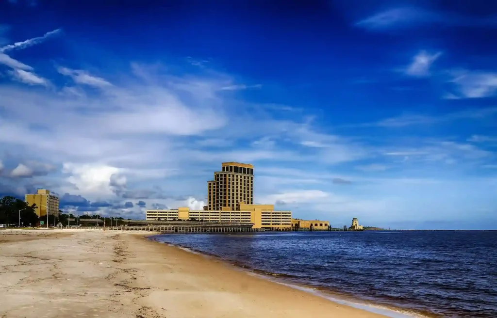 Biloxi, Mississippi sandy beach and waterfront hotels beneath a bright blue sky.