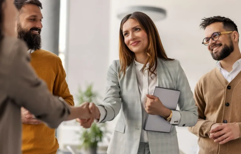 Corporate relocation consultant greeting employees during an office meeting.