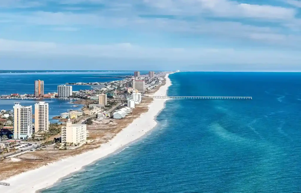 Pensacola, Florida aerial view of white sand beaches, blue Gulf water, and a long fishing pier.